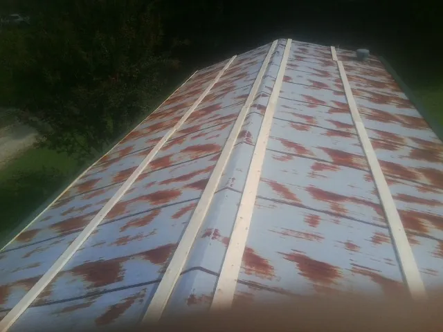 Rusted metal roof panels with new wood purlins before replacement — Storm Damage Roof Repair in Guatay by Roofing Brothers